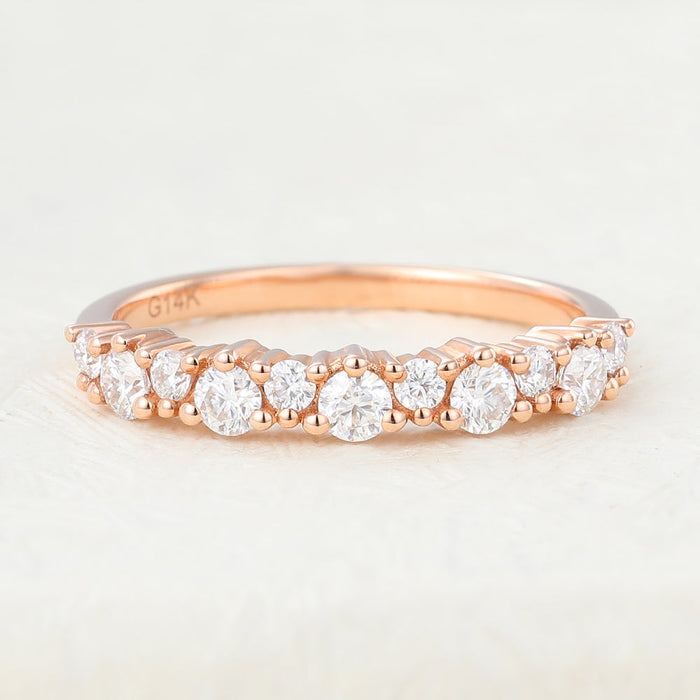 Rose gold round moissanite band with alternating large and small stones, front view