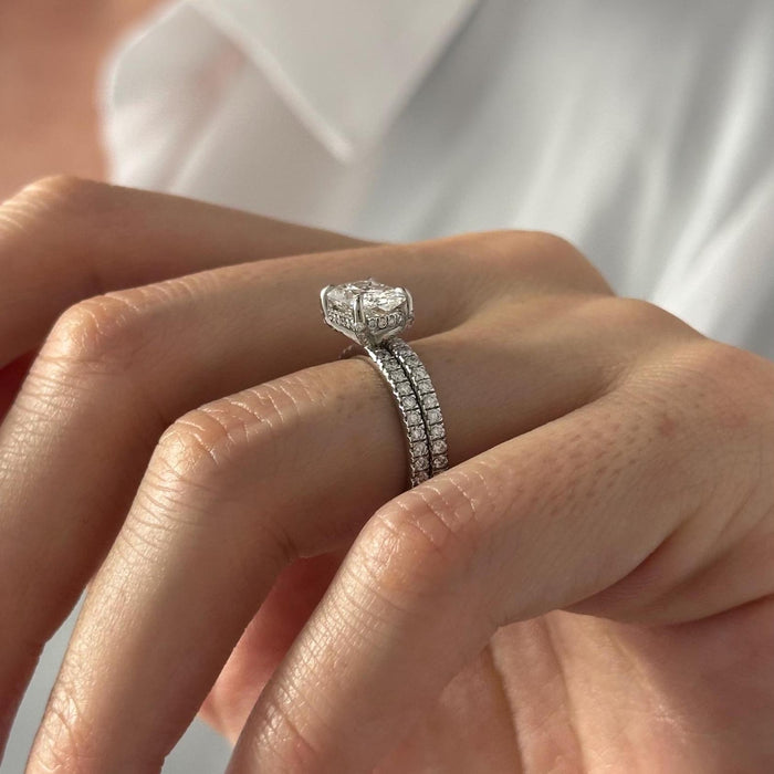 Side view of cushion lab grown diamond engagement ring showing the hidden halo and pave shank with the pave wedding band