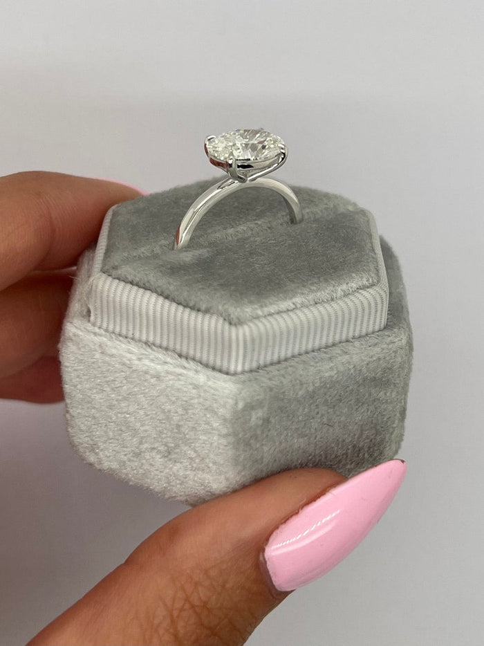 Oval diamond set across the finger in a four claw east west setting