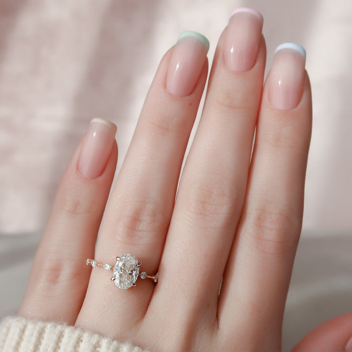 Oval moissanite solitaire ring with accent stones, front view