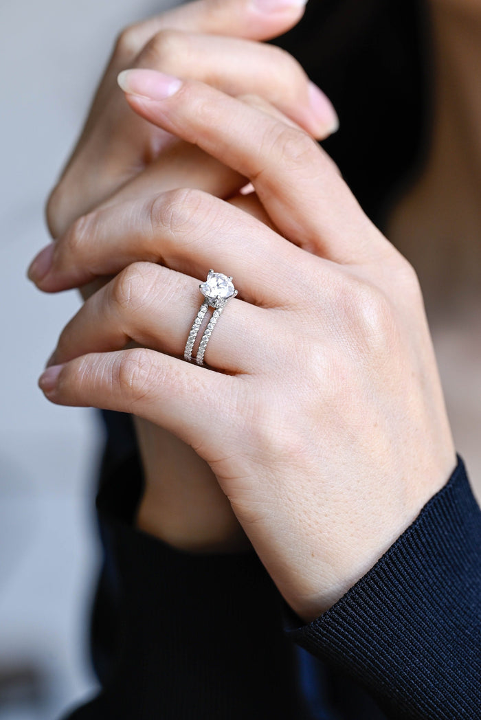 Heart cut moissanite solitaire engagement ring on a double pave set split white gold band, view 2