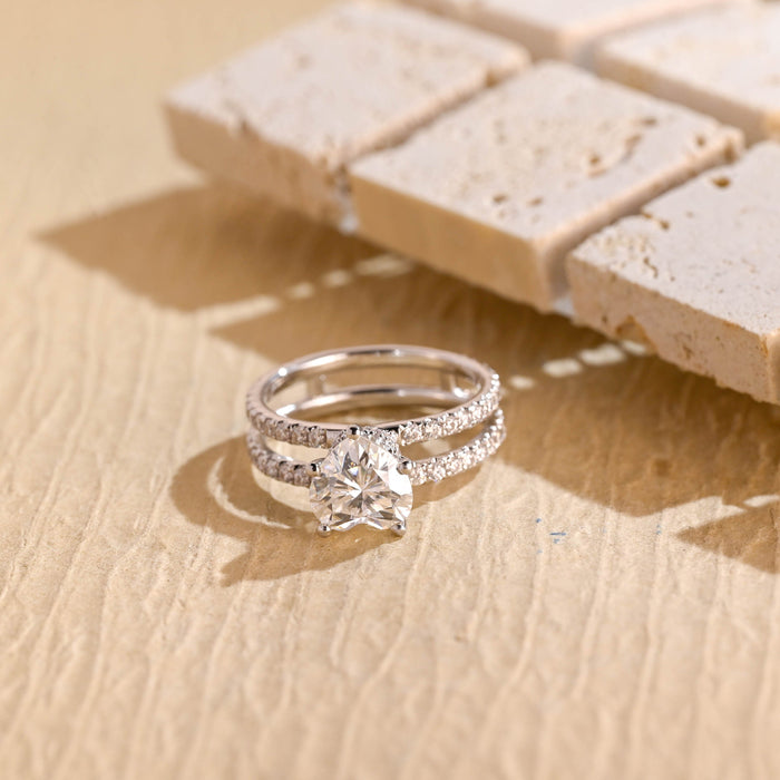 Heart cut moissanite solitaire engagement ring on a double pave set split white gold band