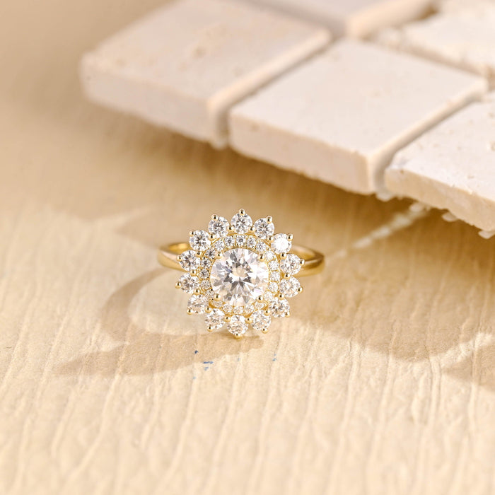 Round moissanite double halo sunburst engagement ring with a pave inner halo and an outer ring of larger round stones like petals on a slim yellow gold band