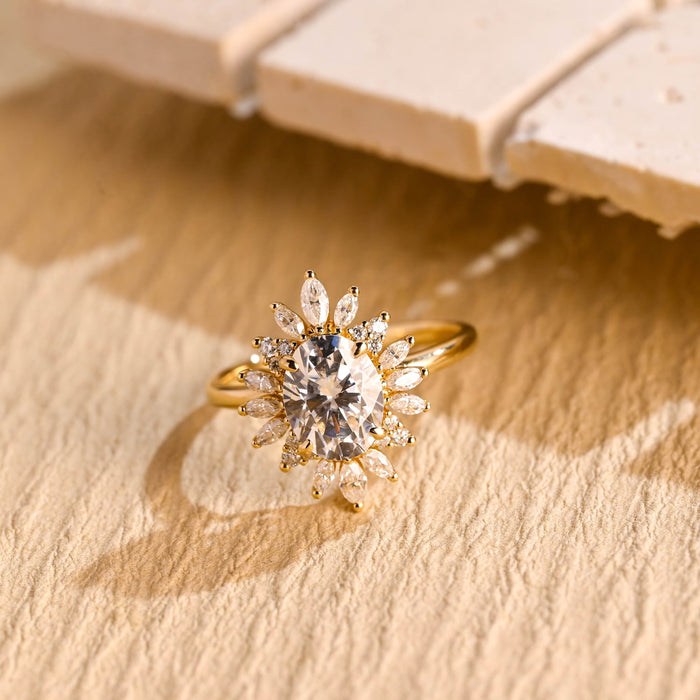 Oval moissanite sunflower halo engagement ring with radiating marquise petals and small round stone clusters on a slim plain yellow gold band