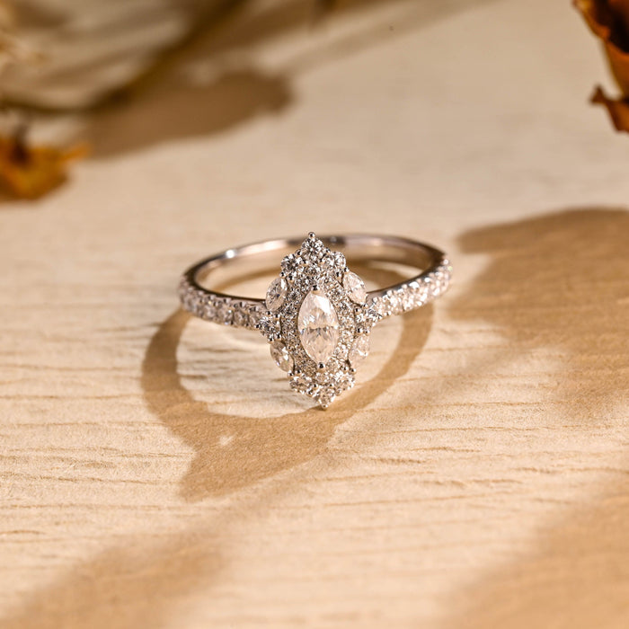 Marquise cut moissanite cluster halo engagement ring with four small marquise accent stones and a pave set white gold band