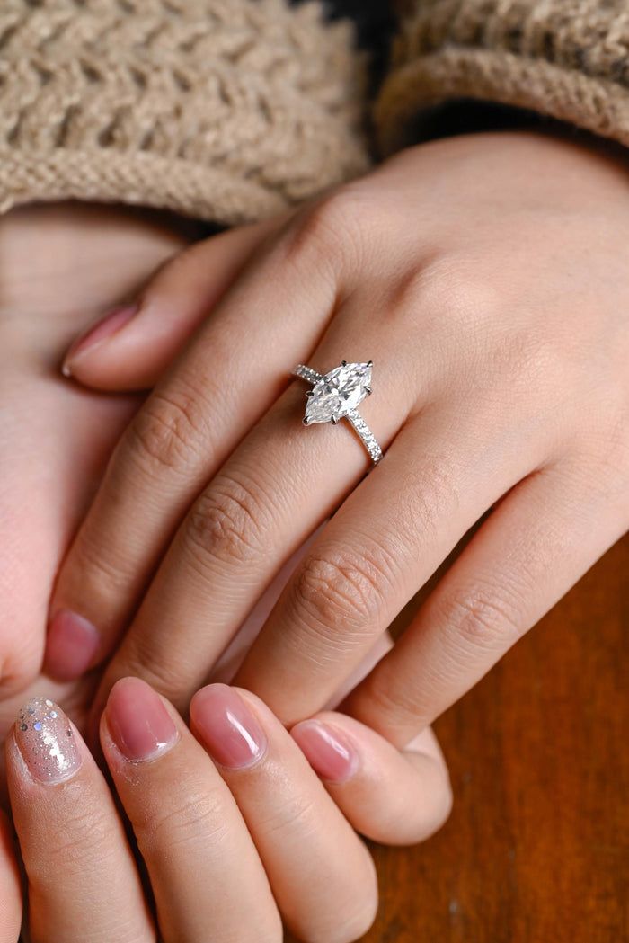 Elongated marquise cut moissanite six claw solitaire engagement ring with pave set shoulders on a white gold band, view 2
