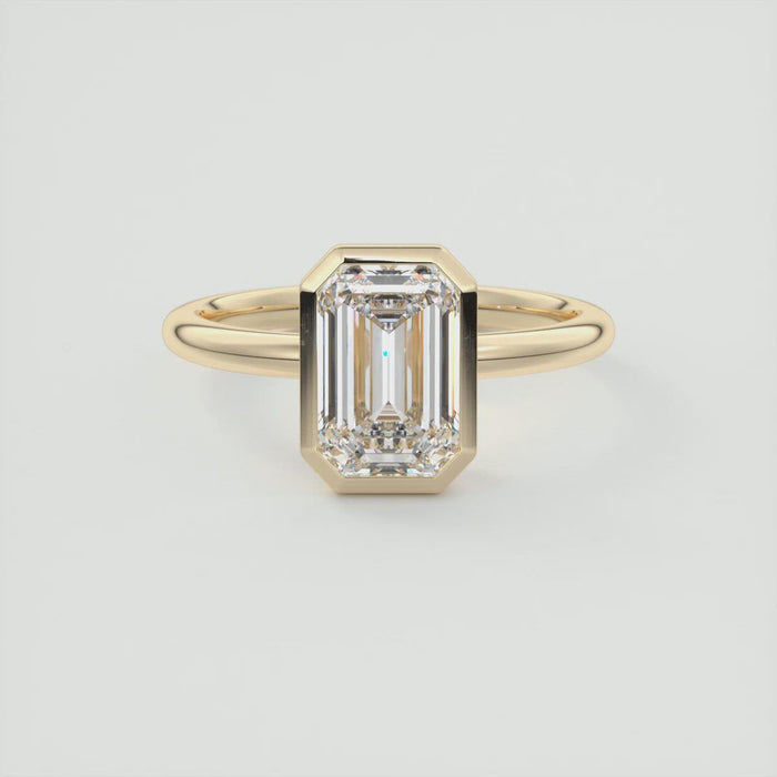 Emerald cut moissanite full bezel solitaire engagement ring in yellow gold