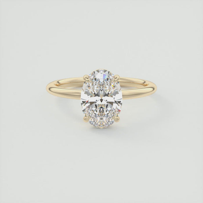 Oval cut moissanite low profile solitaire engagement ring in yellow gold