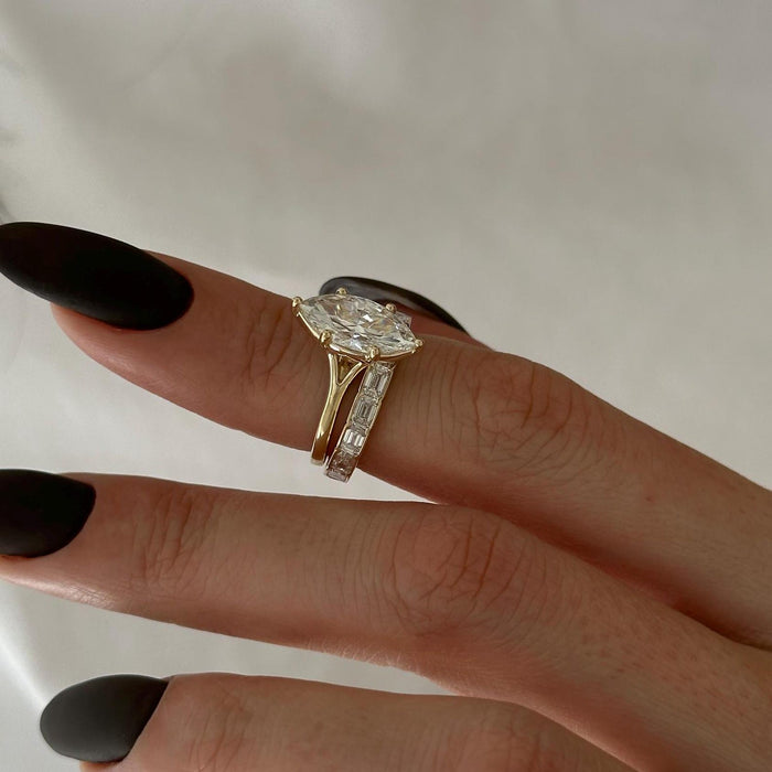 Side view of marquise lab grown diamond ring showing the split shank beside an east-west emerald-cut band