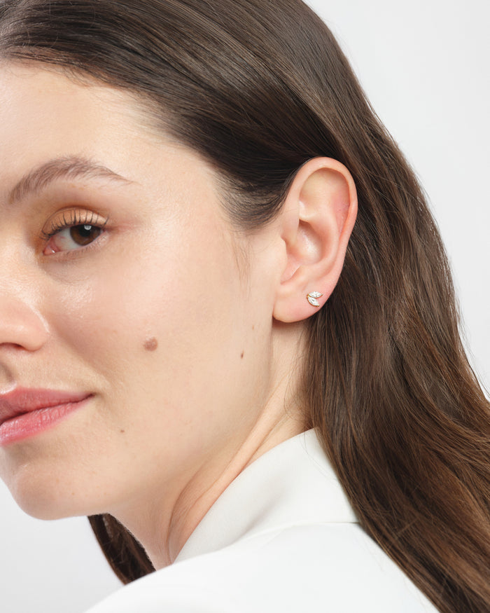 Model wearing marquise duo cluster lab grown diamond stud earrings, close up on the ear