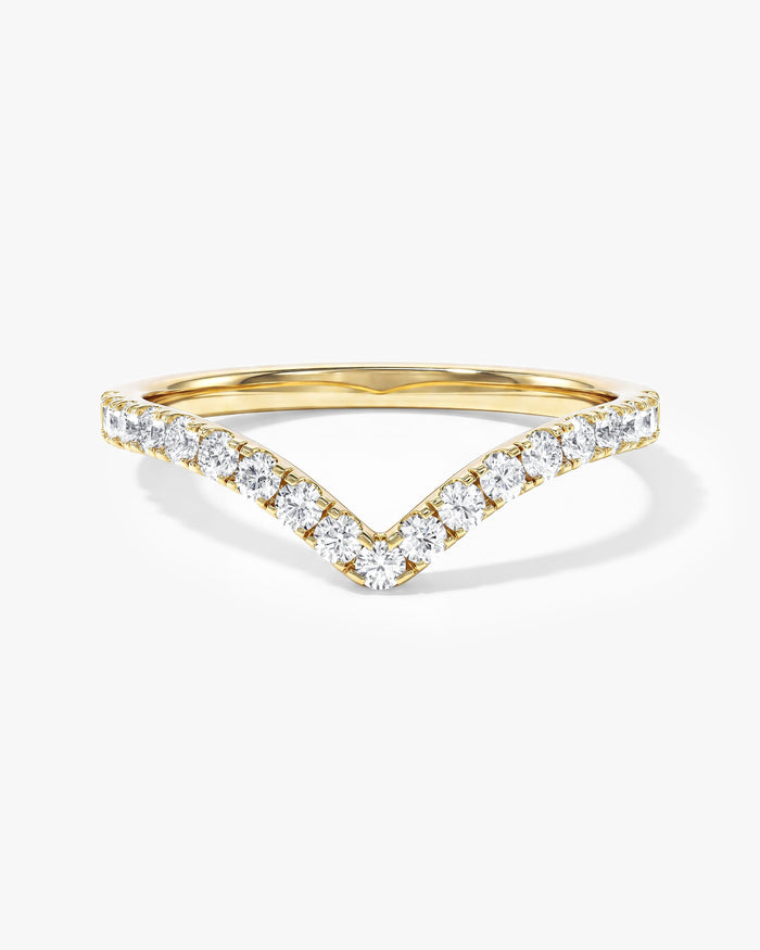 Curved round moissanite wedding band in yellow gold