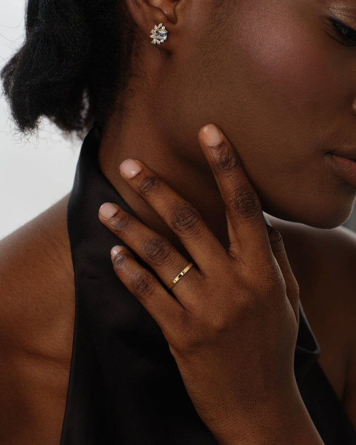 Woman wearing a slim 2mm flat gold wedding band
