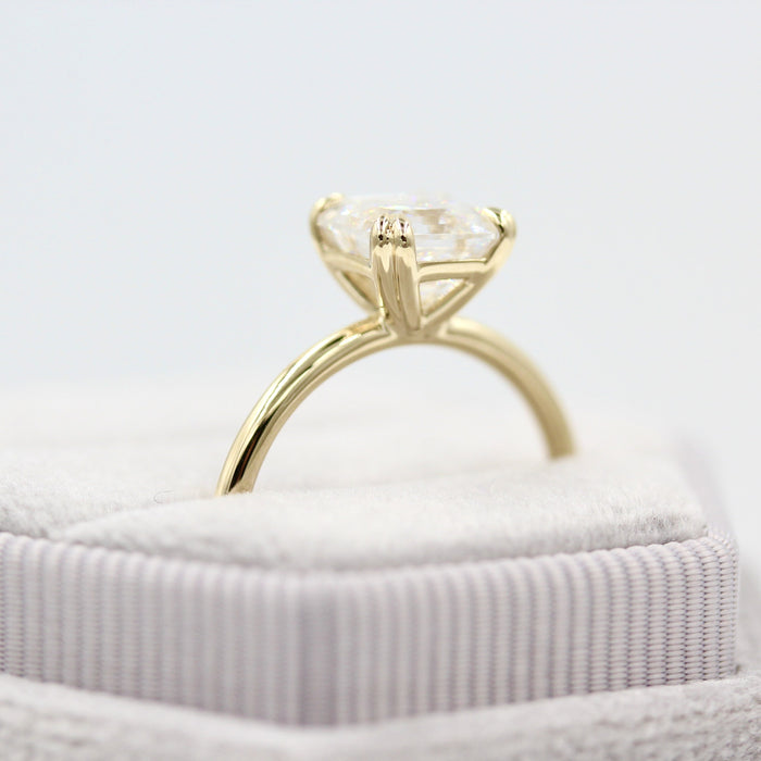 Asscher cut moissanite double claw solitaire engagement ring on a rounded yellow gold band, view 2