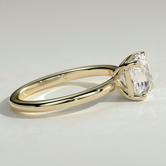 Asscher cut moissanite four claw solitaire engagement ring on a plain yellow gold band, view 2