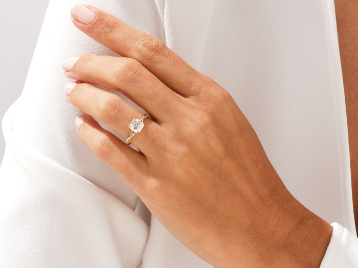 Asscher moissanite infinity twist ring worn on the ring finger