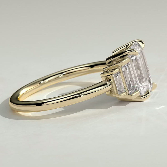 Emerald cut moissanite bar set baguette three stone engagement ring in yellow gold, view 2