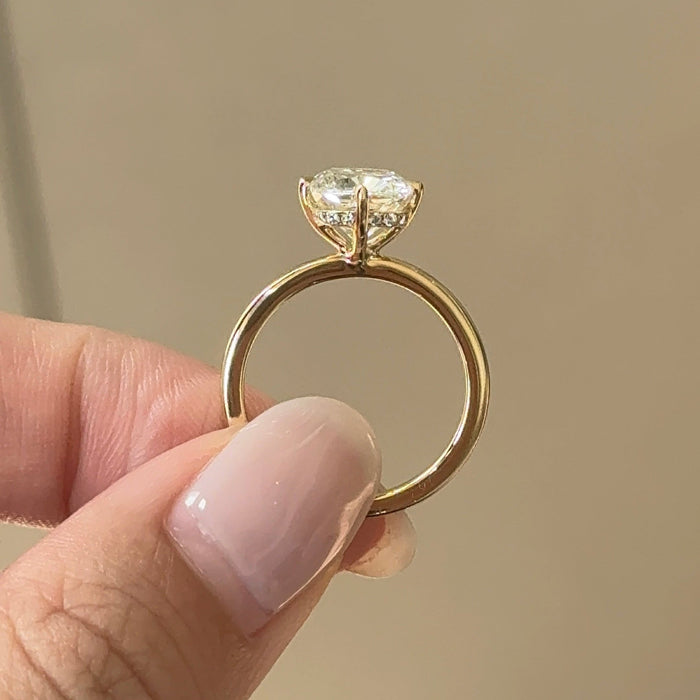 Elongated cushion moissanite hidden halo engagement ring with compass claws in yellow gold, view 2