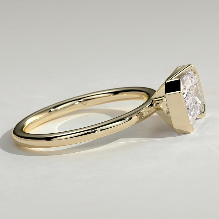 East west emerald cut moissanite corner panel bezel engagement ring in yellow gold, view 2
