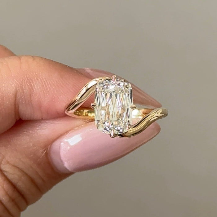 Elongated cushion moissanite swirl bypass solitaire engagement ring in yellow gold