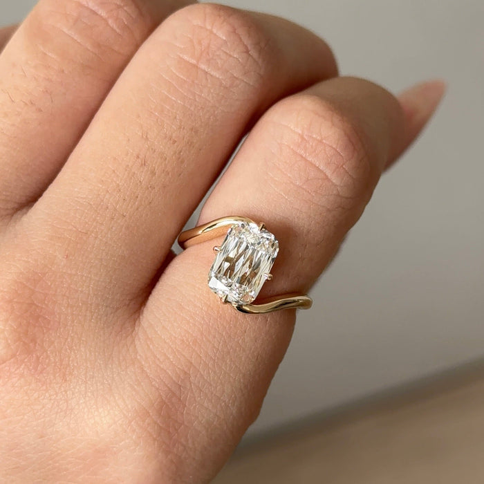 Elongated cushion moissanite swirl bypass solitaire engagement ring in yellow gold, view 2