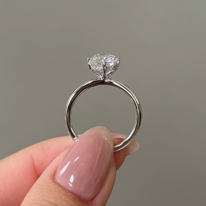 Elongated cushion moissanite hidden halo engagement ring on a fine round white gold band, view 2