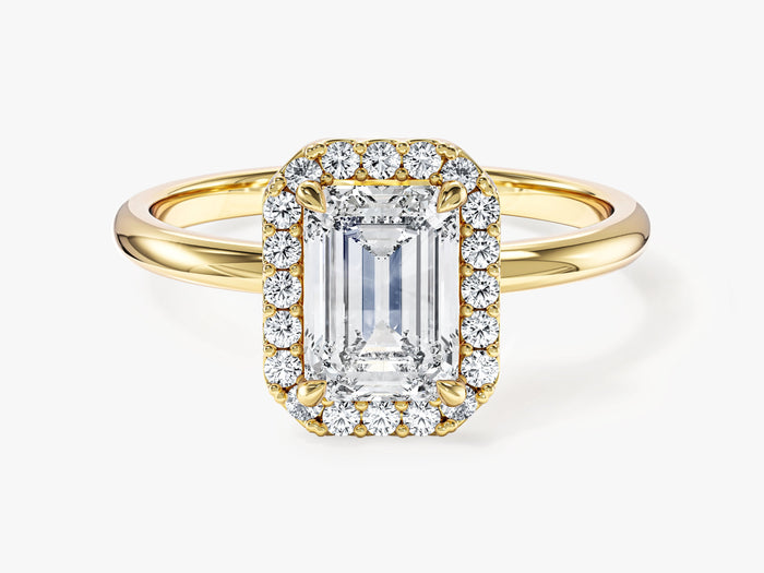 Emerald lab grown diamond octagon halo engagement ring in yellow gold, front view on a light background