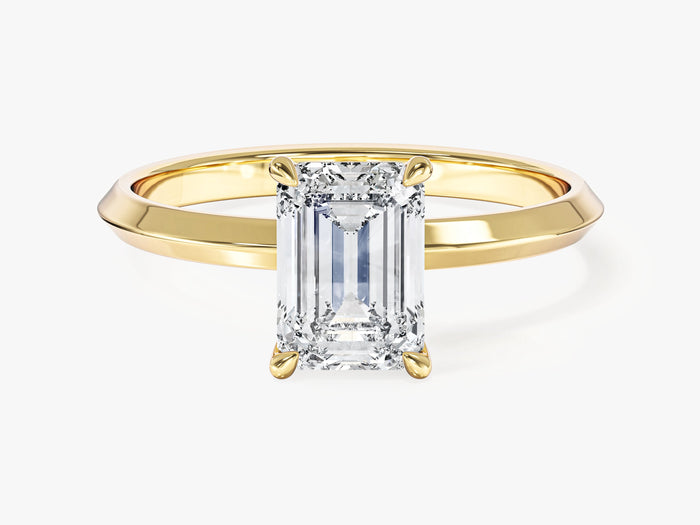 Four prong emerald cut lab grown diamond engagement ring with knife edge band in yellow gold, front view