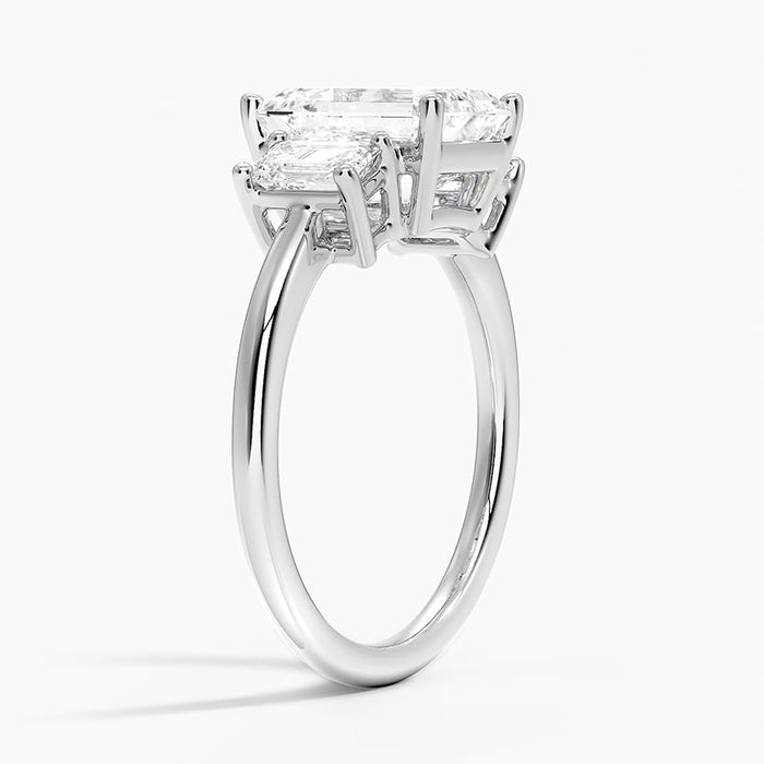 Side profile showing the three step cut stones and slim plain band