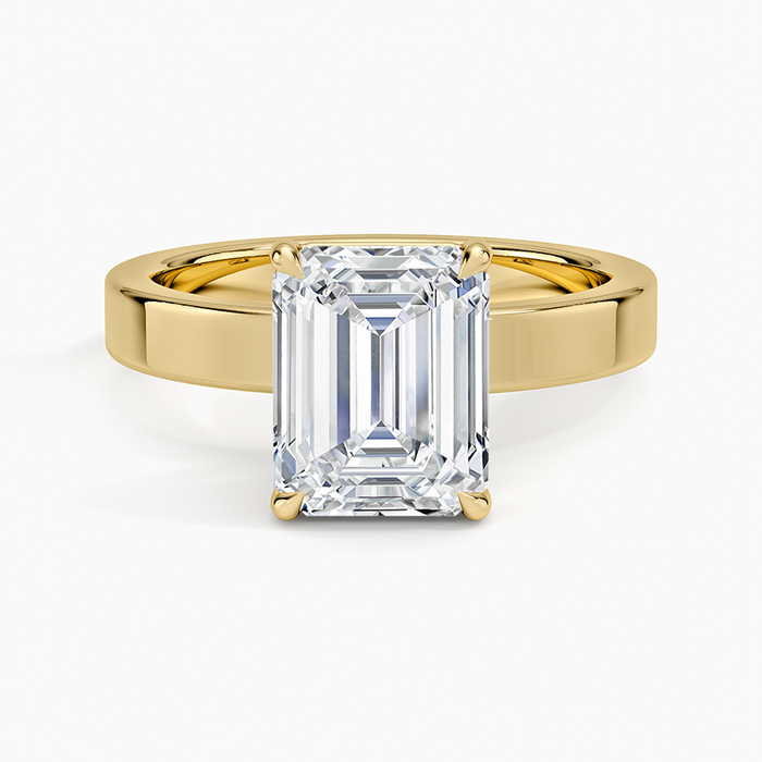 Emerald cut moissanite flat edge band solitaire ring in yellow gold, top view