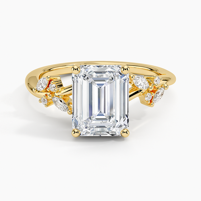 Emerald cut moissanite ring with scattered marquise petal accents in yellow gold, top view