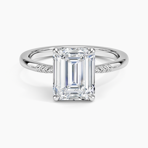 Emerald cut moissanite solitaire with engraved leaf and vine shoulders in white gold, top view