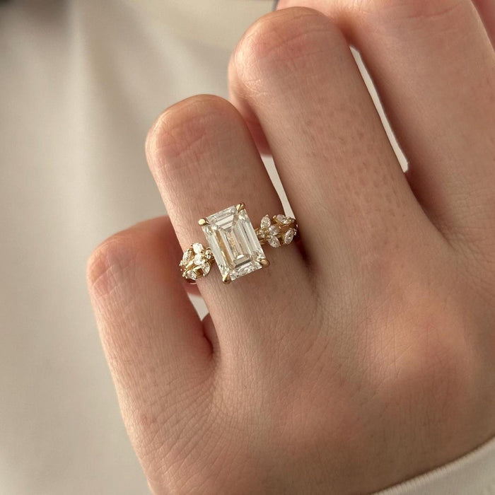 Emerald cut moissanite nature inspired vine engagement ring with hidden halo in yellow gold