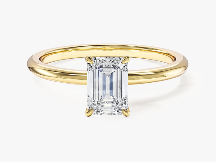 Emerald cut lab grown diamond four claw solitaire engagement ring in yellow gold, front view