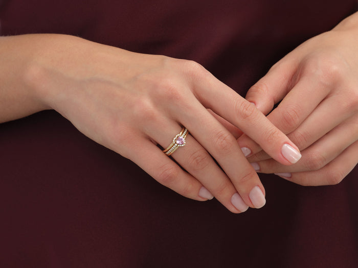 Heart moissanite pave engagement ring stack worn on the hand, fingers clasped