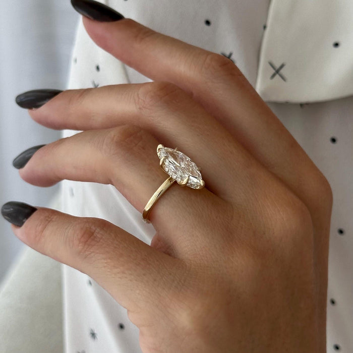 Marquise cut moissanite solitaire engagement ring on a fine band in yellow gold, view 2