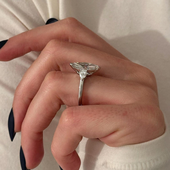 Marquise cut moissanite three stone engagement ring with close set pear side stones in white gold, view 2