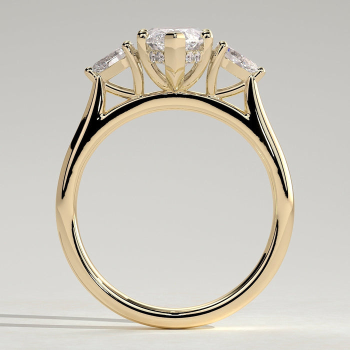 Marquise moissanite three stone engagement ring with pear side stones on a fine yellow gold band, view 2