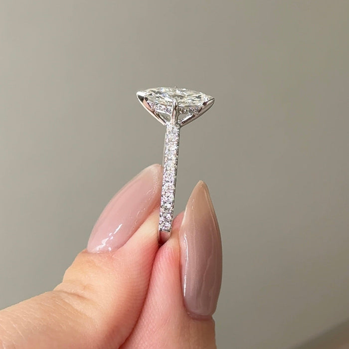 Marquise cut moissanite solitaire engagement ring on a pave set white gold band, view 2