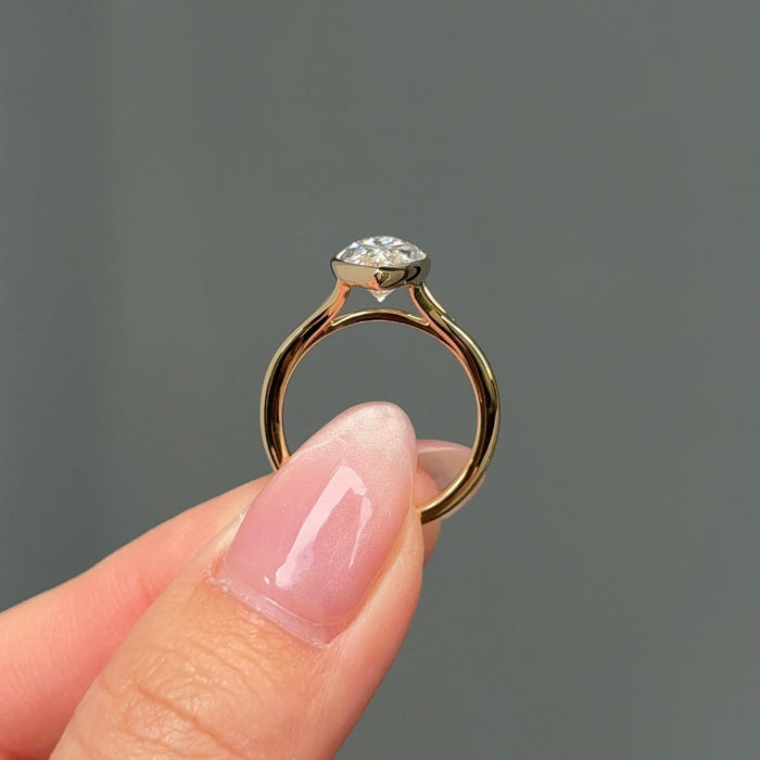 Marquise cut moissanite tapered bezel solitaire engagement ring in yellow gold, view 2