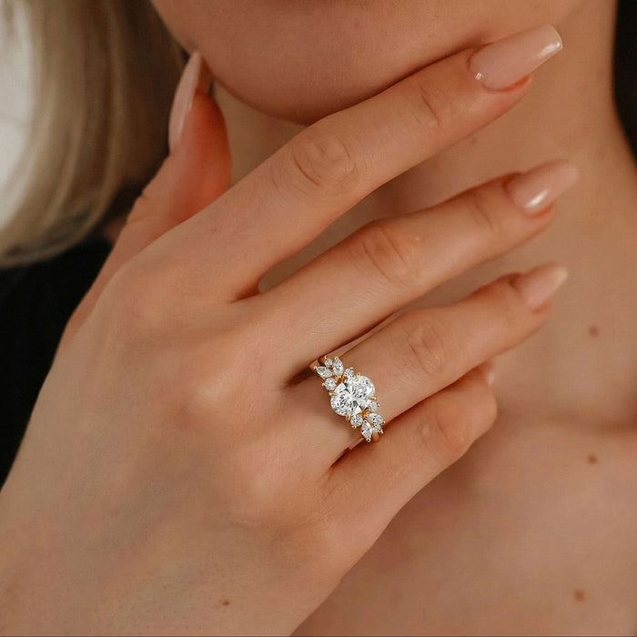 Oval cut moissanite butterfly wing mixed cluster engagement ring in yellow gold, view 2