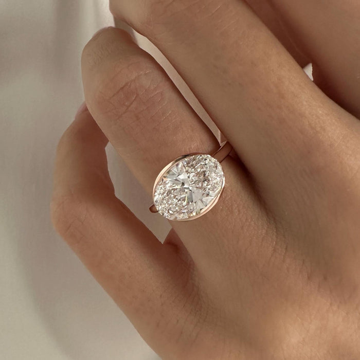 Oval cut moissanite bezel set solitaire engagement ring in rose gold, view 2