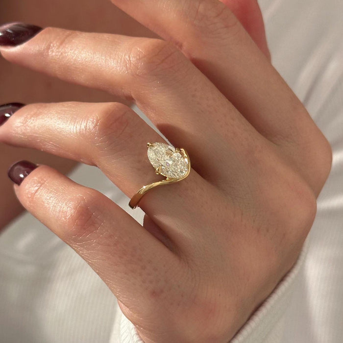 Oval cut moissanite curved bypass solitaire engagement ring in yellow gold, view 2