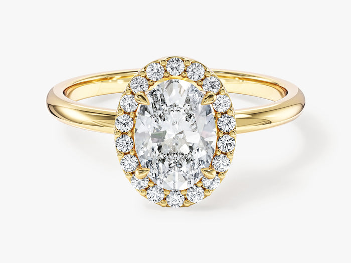 Oval cut moissanite halo engagement ring with slim polished band in yellow gold, front view
