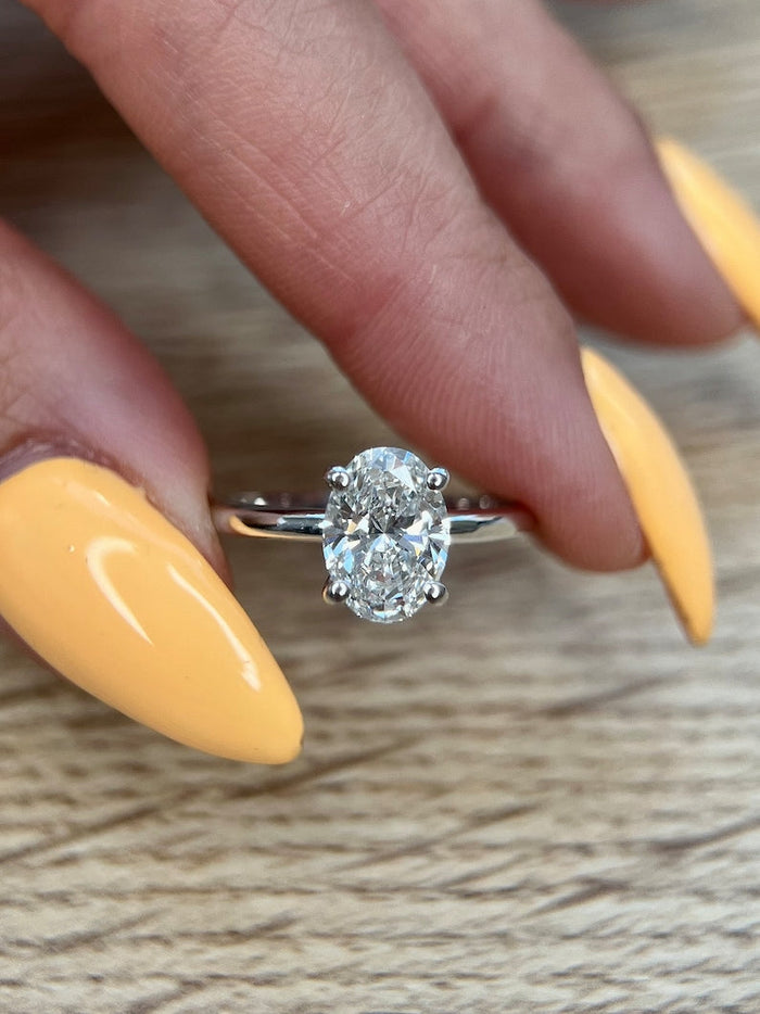 Oval cut moissanite cathedral shoulder solitaire engagement ring in white gold