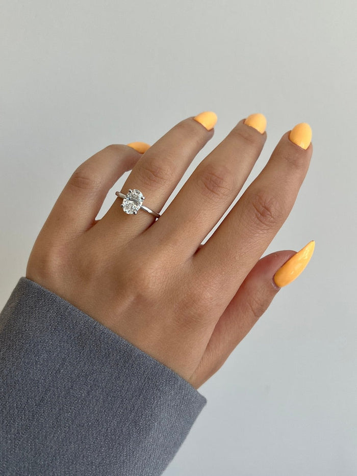 Oval cut moissanite cathedral shoulder solitaire engagement ring in white gold, view 2