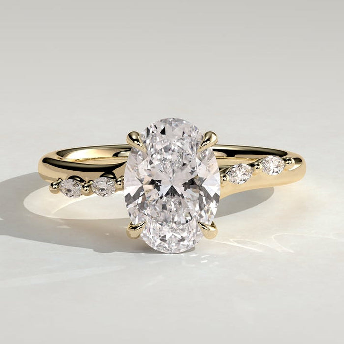Oval cut moissanite engagement ring with dainty alternating accents in yellow gold