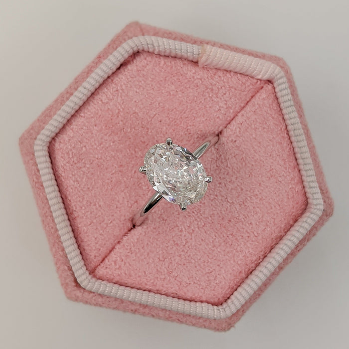 Oval cut moissanite flat tab claw solitaire engagement ring in white gold