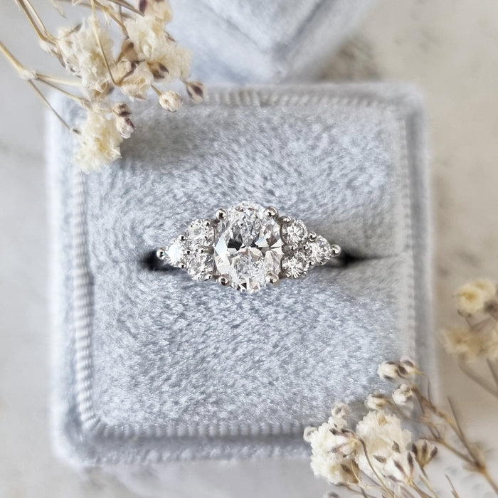 Oval cut moissanite graduated round cluster shoulder engagement ring in white gold, view 2