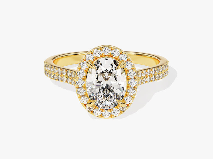 Oval cut moissanite halo engagement ring with two row micro pave shank in yellow gold, front view