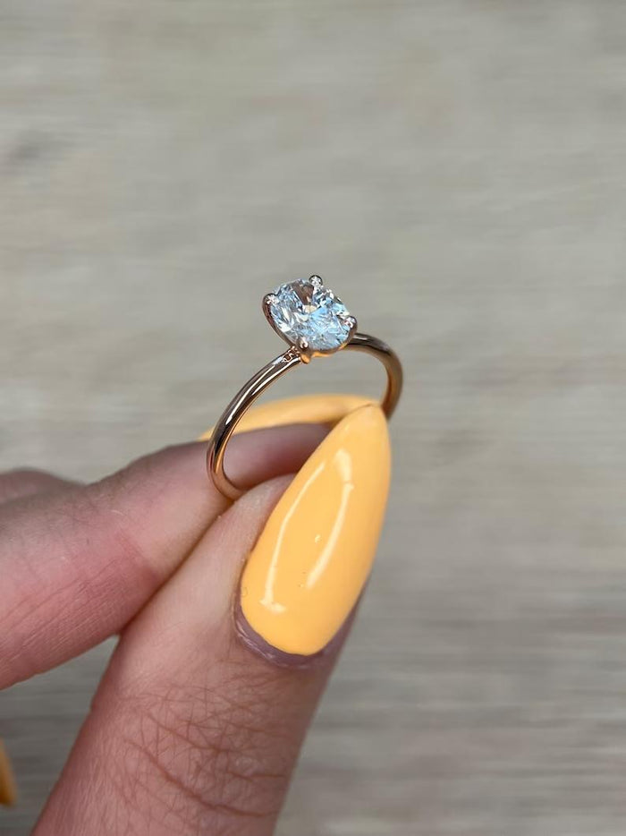 Oval cut moissanite solitaire engagement ring on a hairline flat rose gold band, view 2